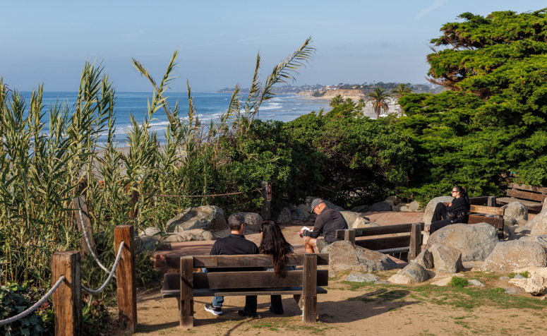 Park Benches with people overlooking the ocean